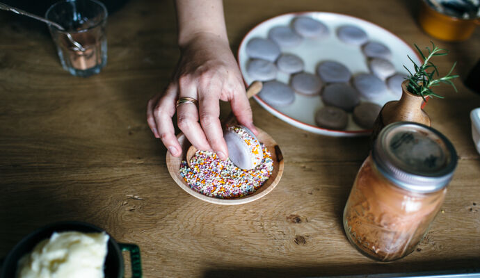 Putting sprinkles on a macaron