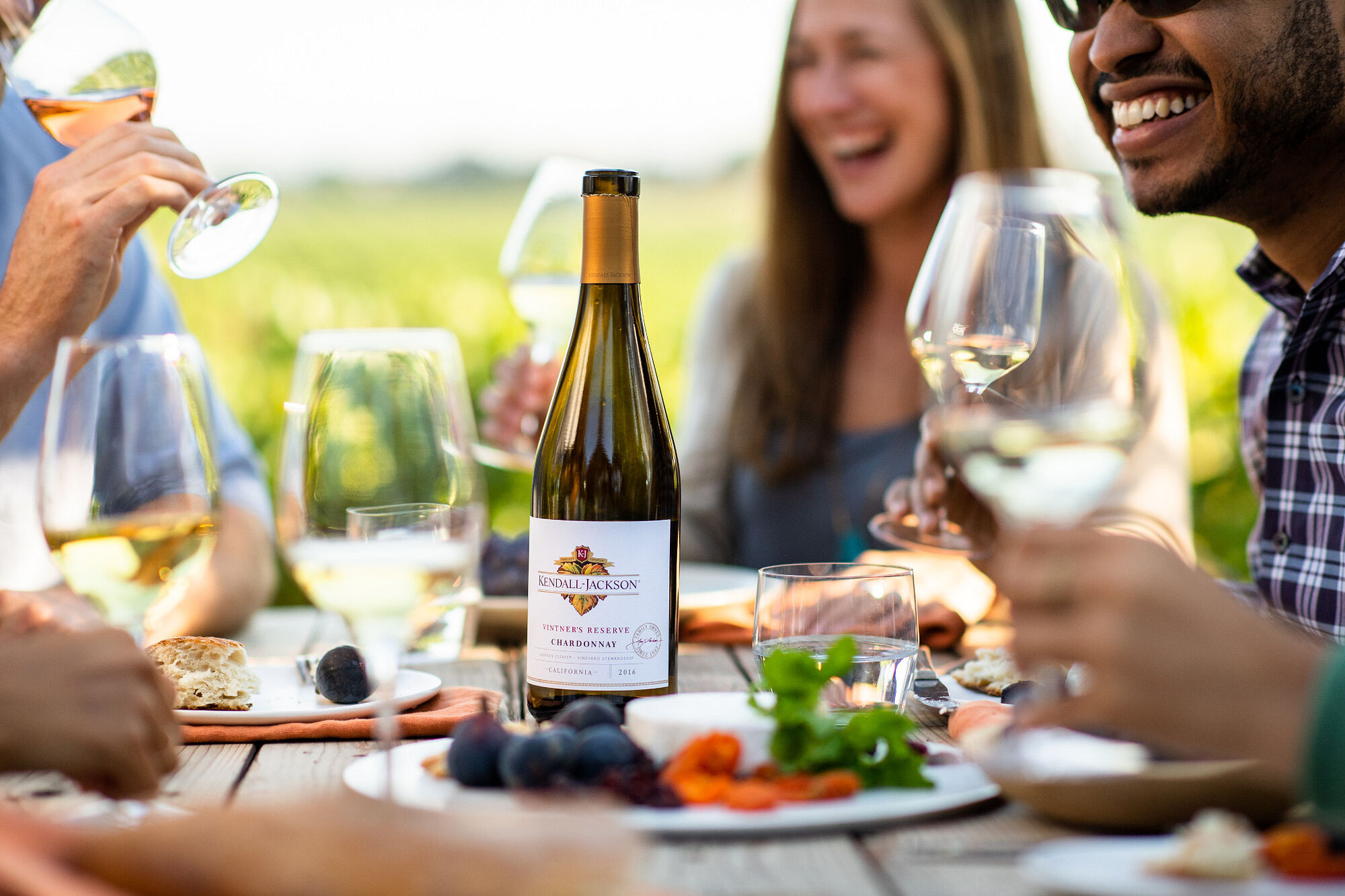 Friends enjoying food with Kendall-Jackson Chardonnay