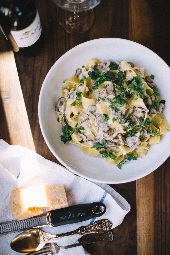 Bowl of mushroom pasta with wine
