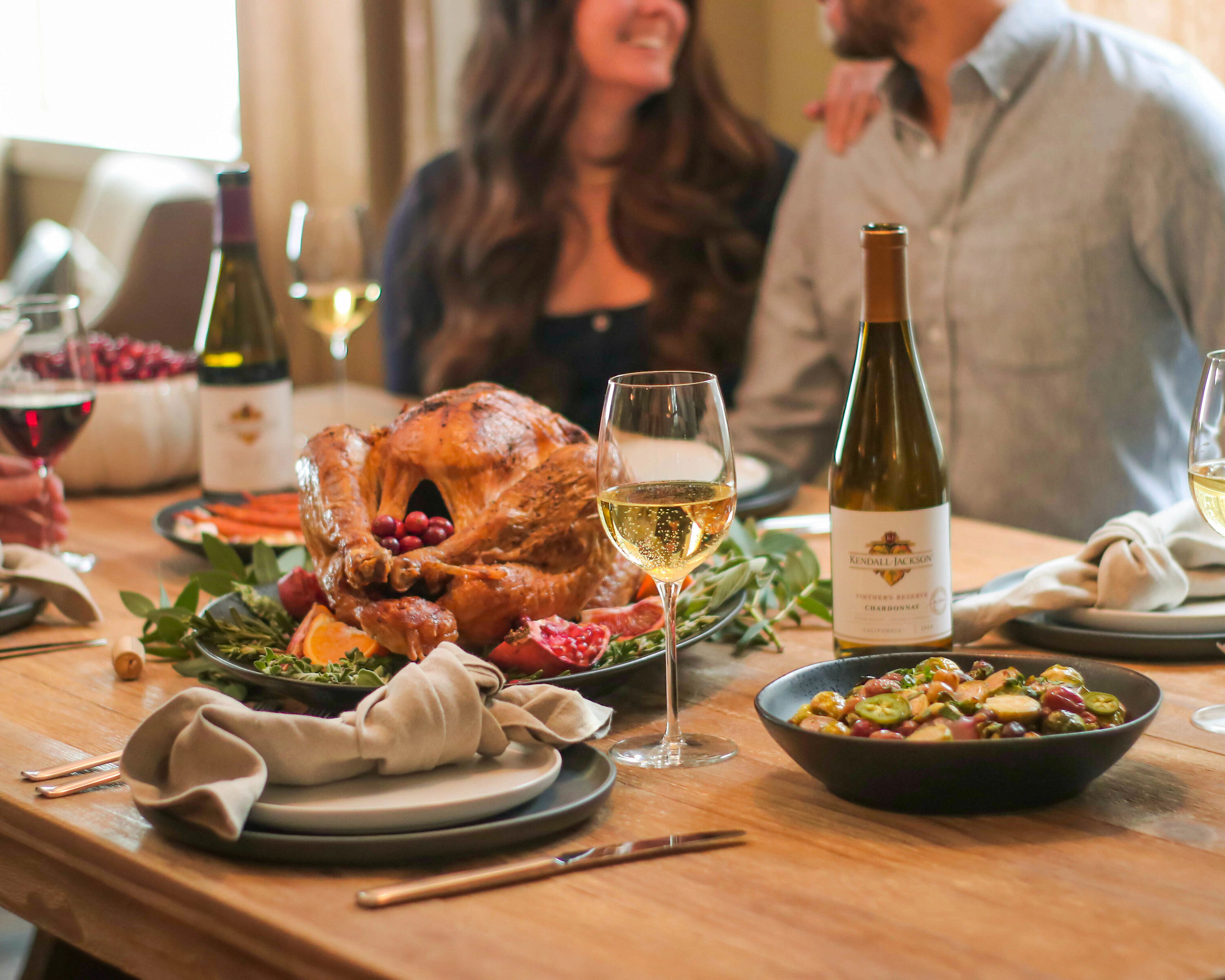 A couple enjoying a Thanksgiving dinner with Kendall-Jackson wine