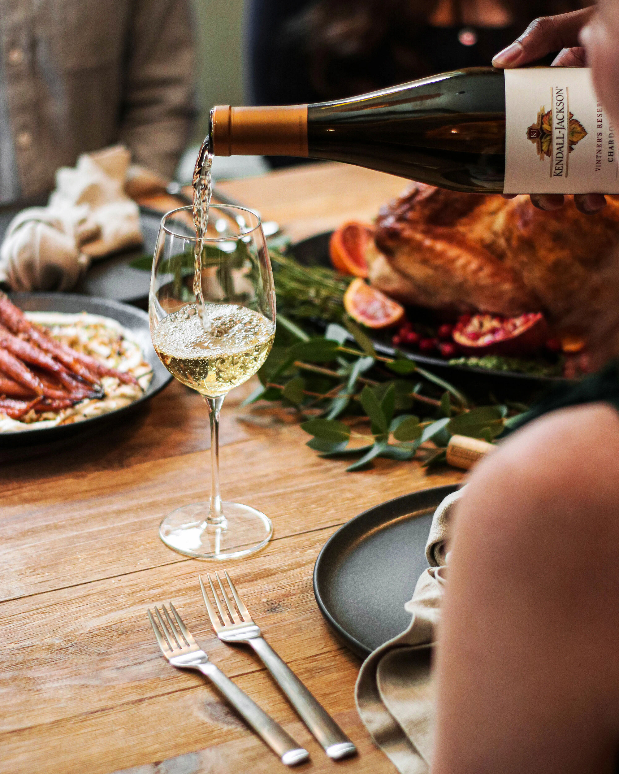 Pouring a glass of Kendall-Jackson Chardonnay at a Thanksgiving dinner