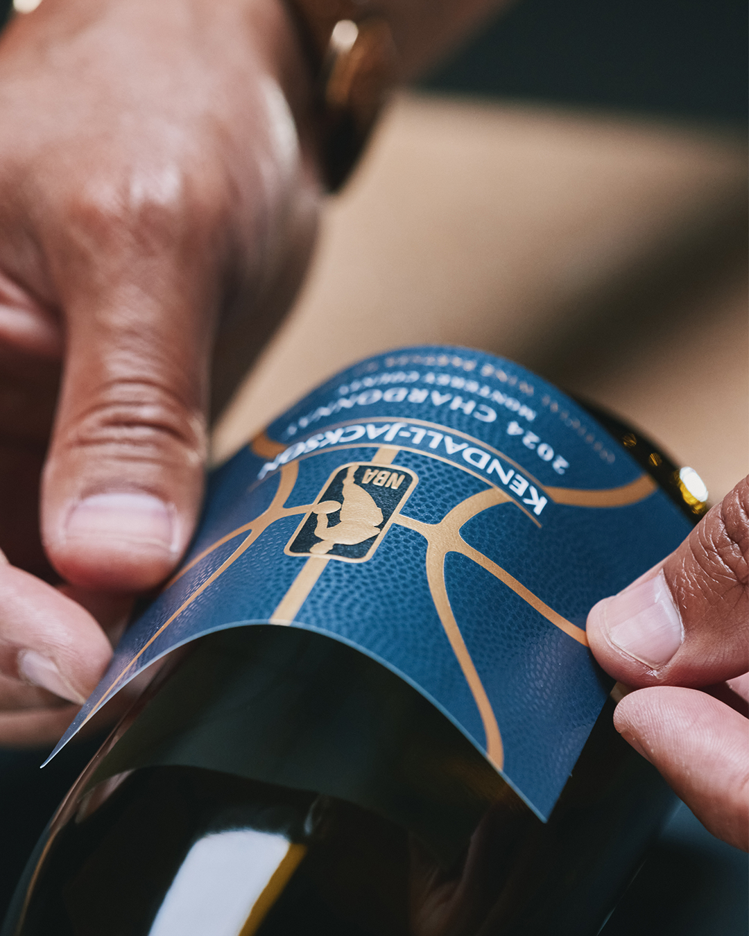 Behind the scenes close-up applying Chardonnay label