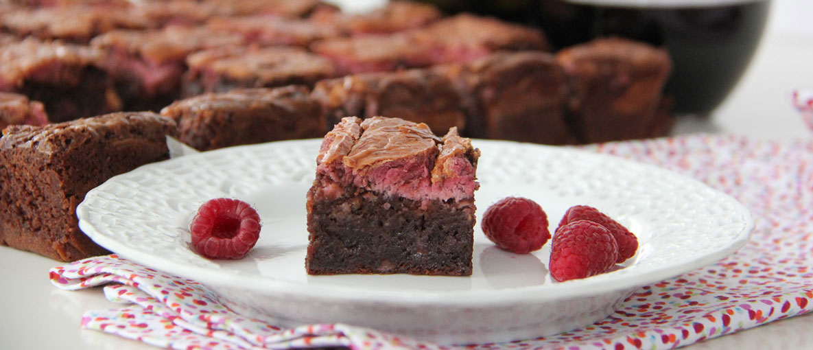 Raspberry Cheesecake Swirl Brownie on a plate with berries