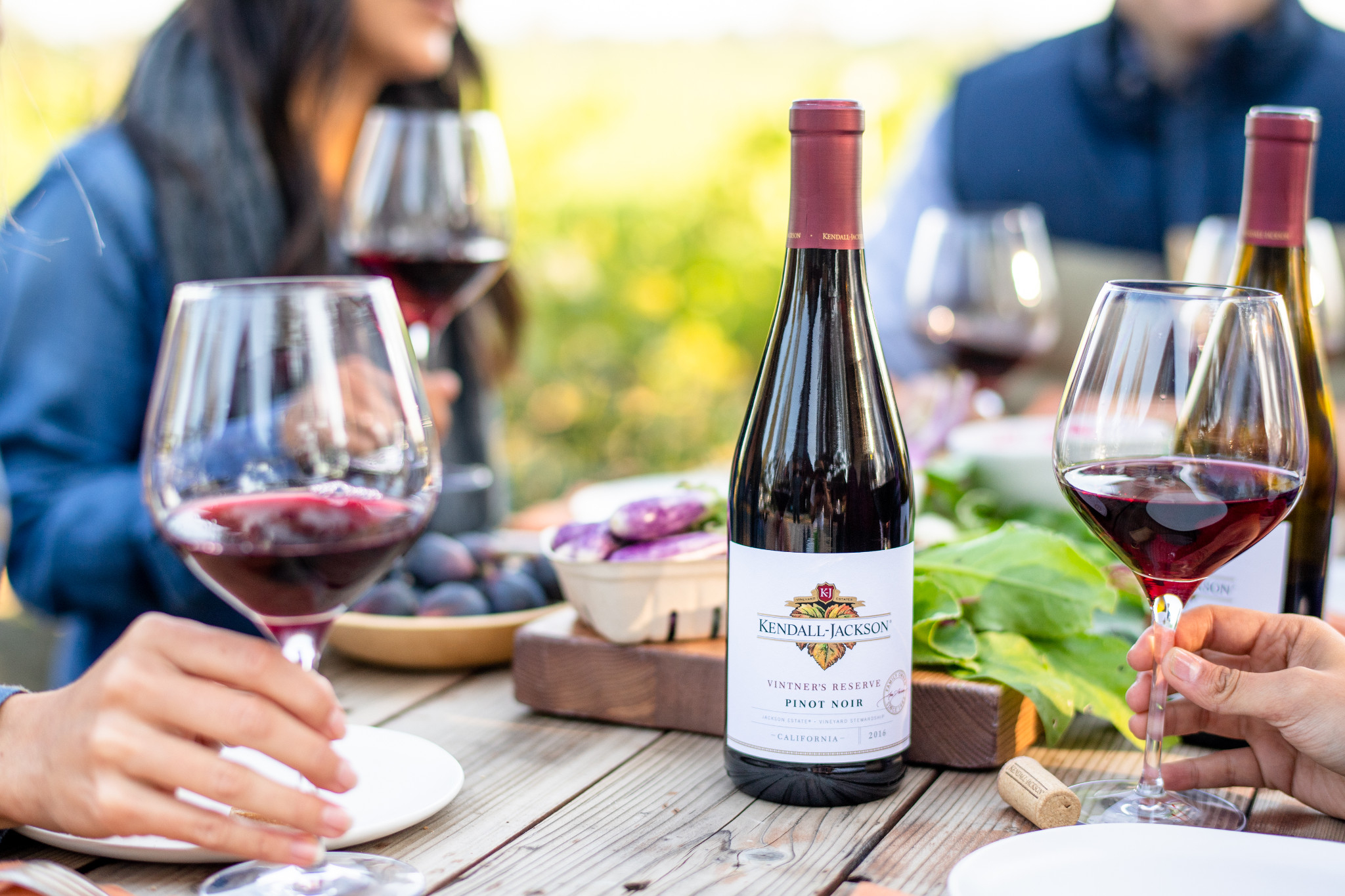 Pinot Noir at a table with friends enjoying some food