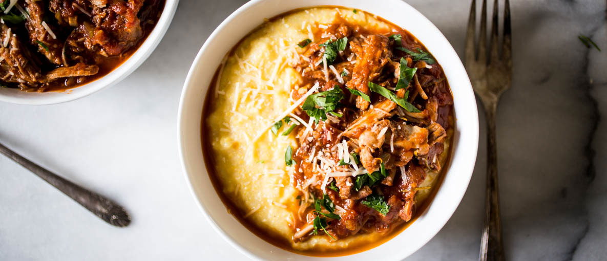 pork ragu side by side in bowl with creamy polenta