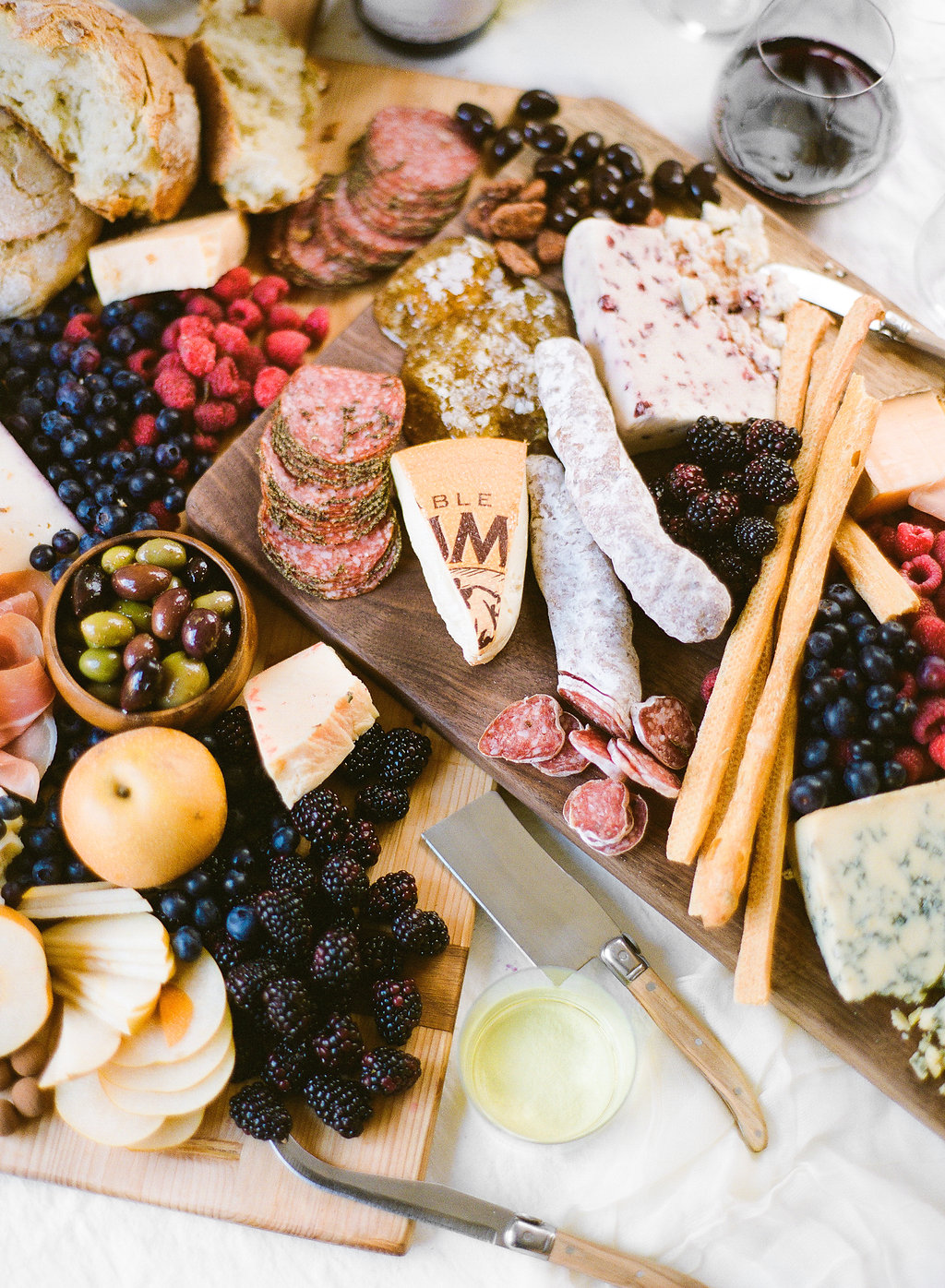 My favorite thing about a wine tasting party is the prep. That might sound weird, but it's fun to put a big beautiful board together full of different fruits, cheeses, proteins, and treats. My approach to building a beautiful spread is to pack it all on.