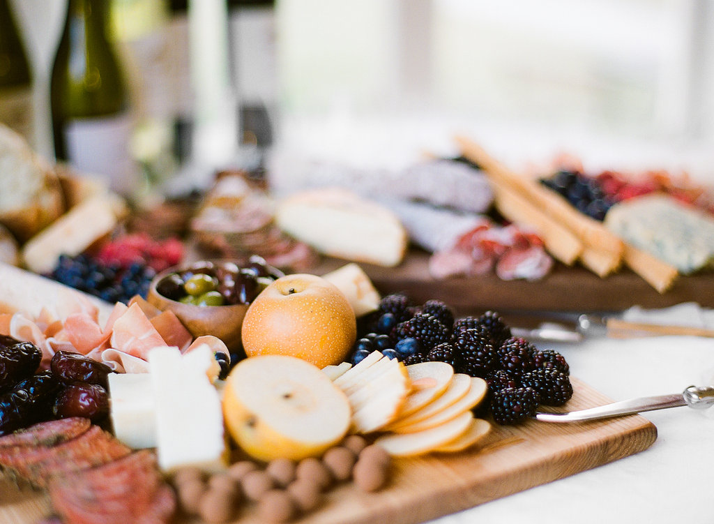 My favorite thing about a wine tasting party is the prep. That might sound weird, but it's fun to put a big beautiful board together full of different fruits, cheeses, proteins, and treats. My approach to building a beautiful spread is to pack it all on.