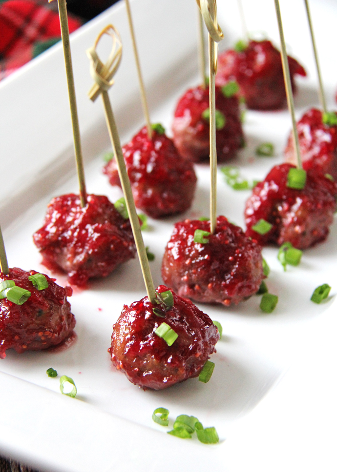 These Turkey Appetizer Meatballs with Cranberry Glaze taste like a turkey dinner wrapped up in a little ball of deliciousness!  The meatballs are savory with flavors of sage and thyme, and the cranberry glaze is sweet and sour, making the pairing perfect. #recipe