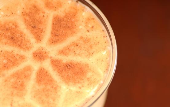 Overhead view of glass of eggnog with nutmeg