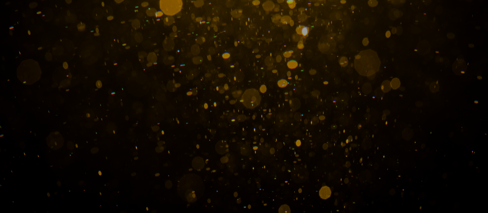 Gold dust falling on black background.